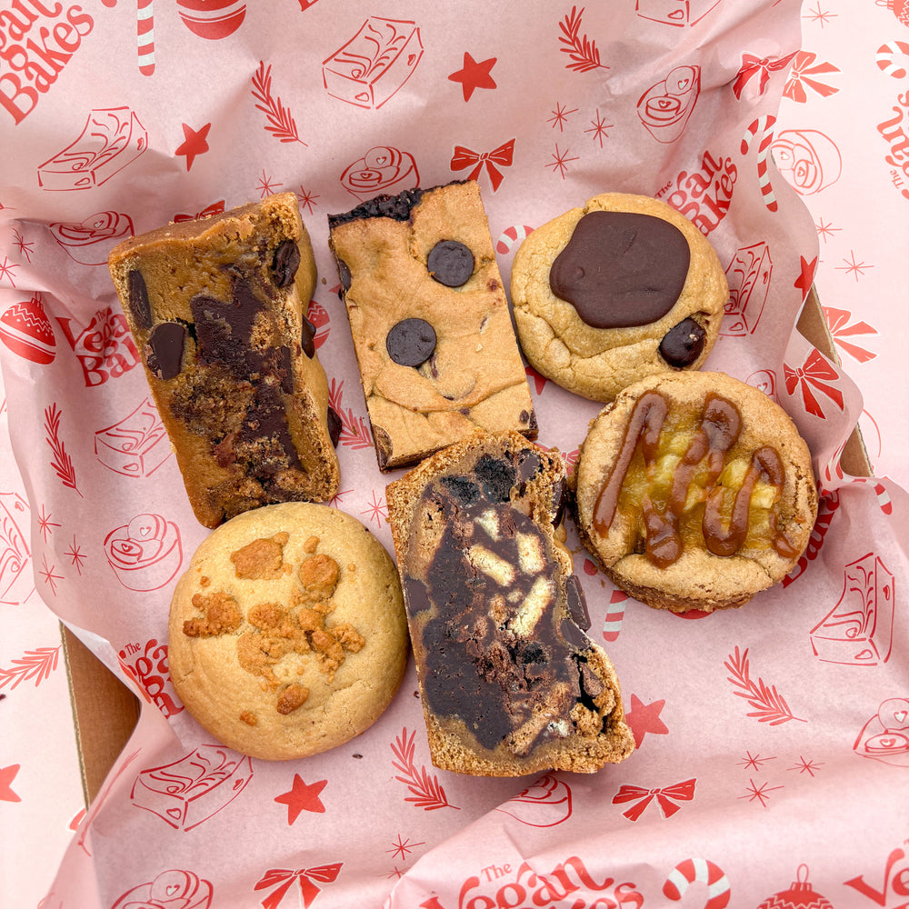 Assorted cookies on a 'Vegan Bakes' branded paper
